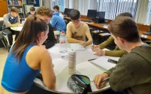 Students gathered around a table during a PSLG session