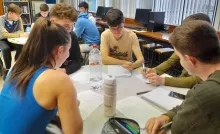 Students gathered around a table during a PSLG session
